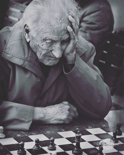 Grayscale Photo of Man Playing Chess